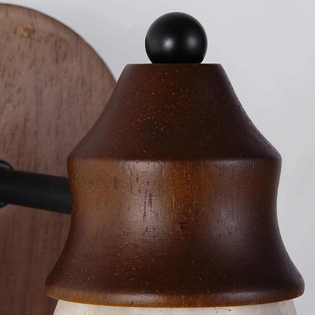 Modern travertine wall light fixture showcasing walnut wood mounting and handcrafted stone construction