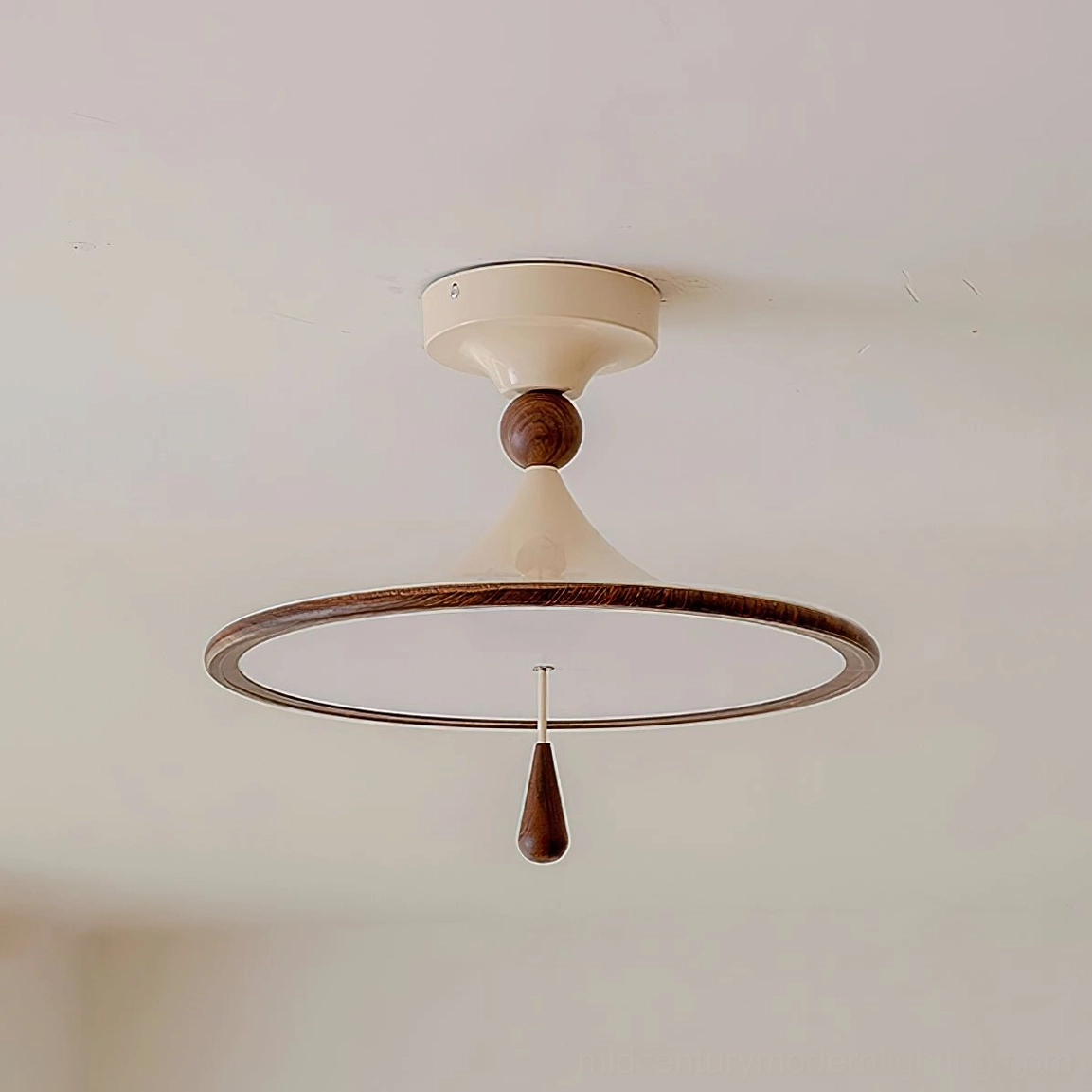 Overhead close-up of Tomaso flush mount ceiling lamp with cream base, walnut accents, and glowing disc shade