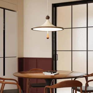 Tomaso pendant light suspended above modern dining table with dark wood furniture and frosted glass partition