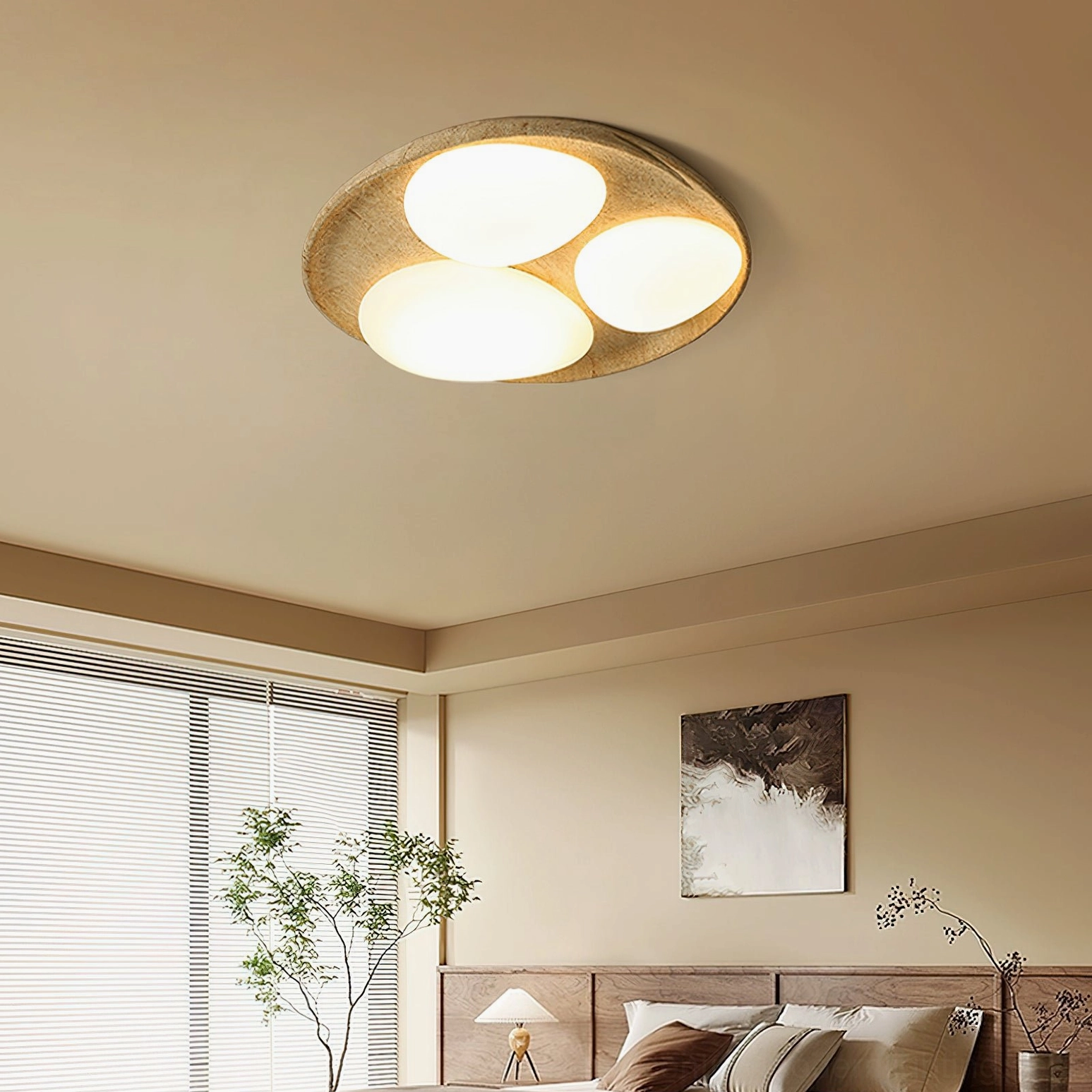 Topo mid-century modern ceiling light installed in minimalist bedroom low angle view with warm ambient glow from three oval lamps