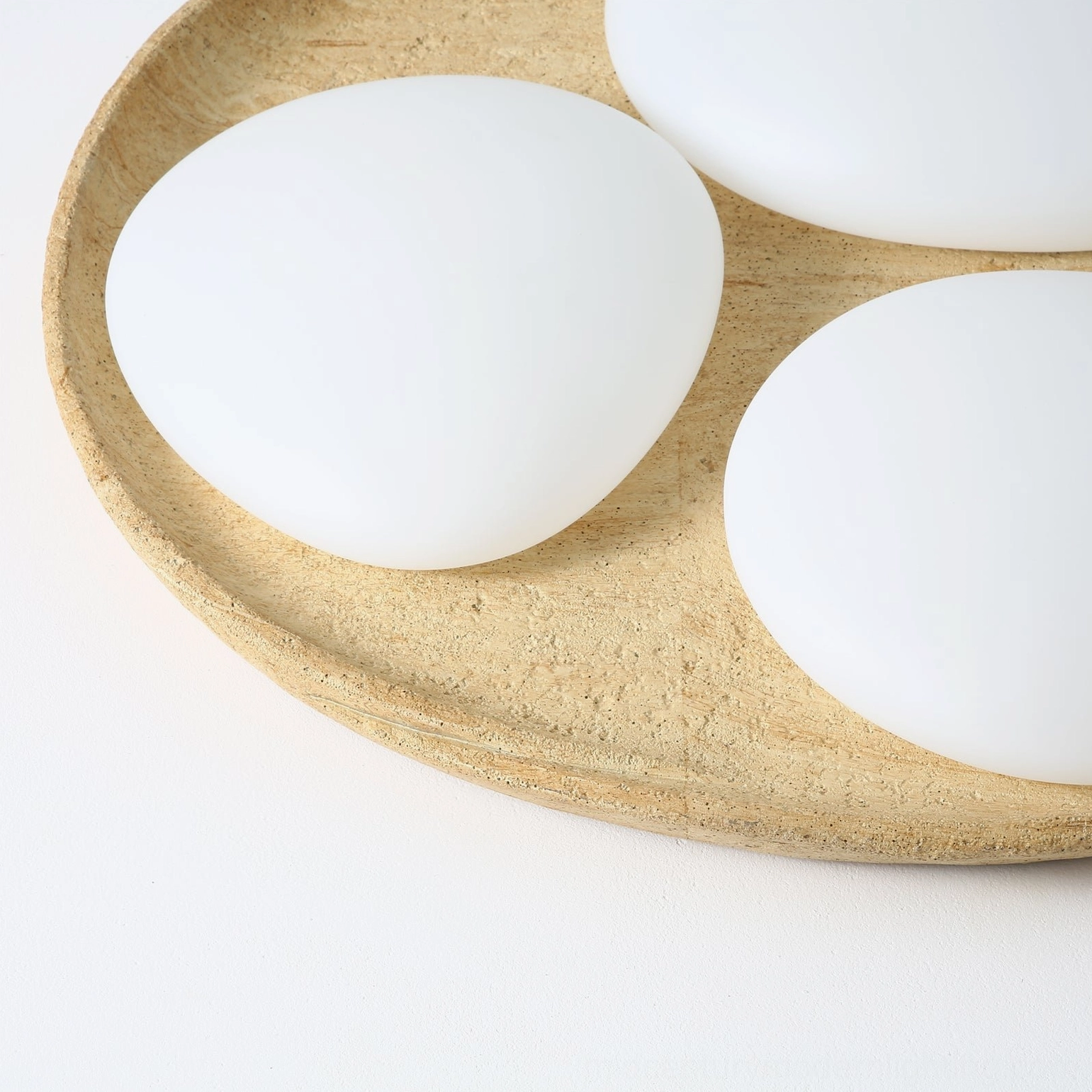 Topo organic ceiling light close-up detail of frosted oval diffusers and stone base demonstrating craftsmanship