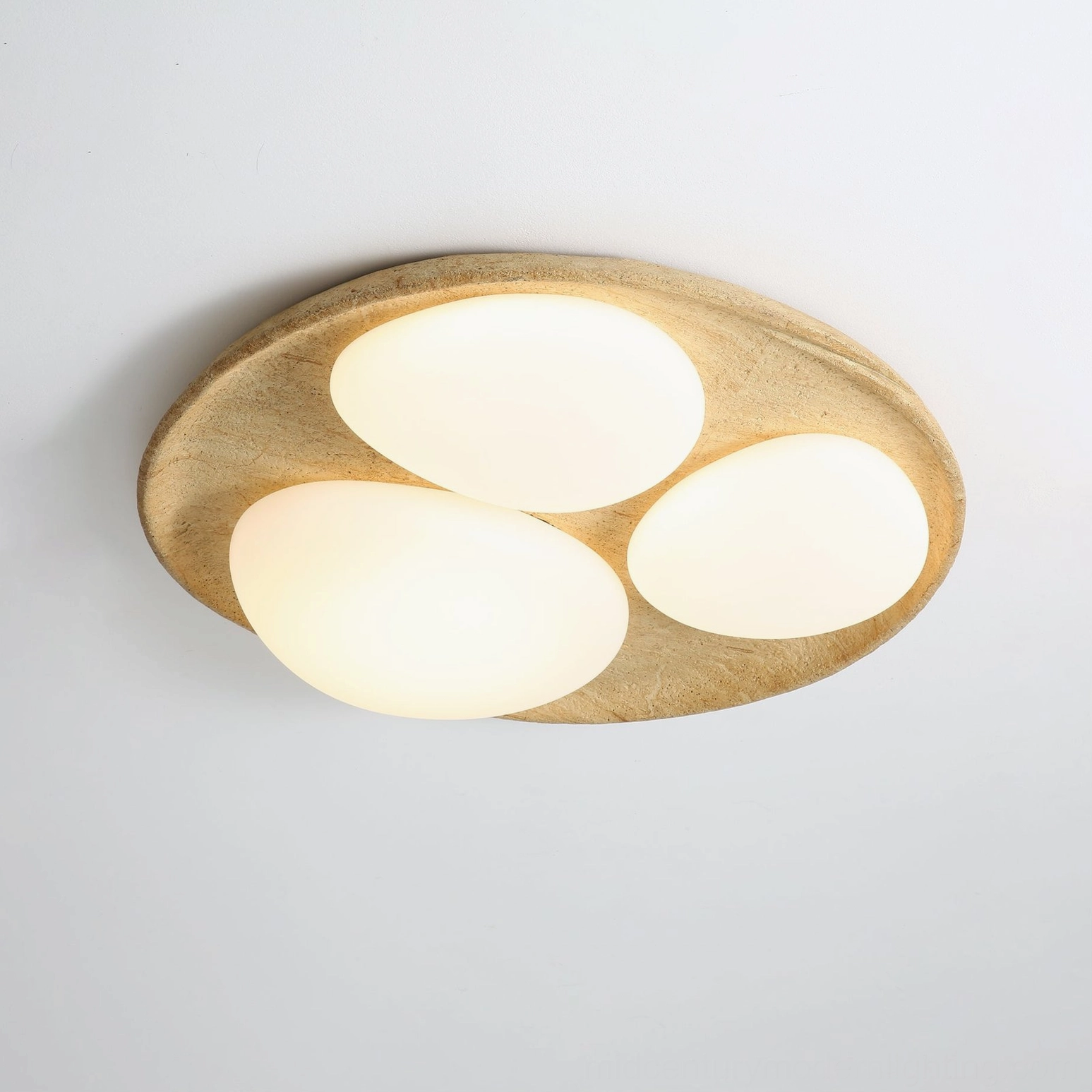 Topo modern organic ceiling fixture installed view from below showing three oval lamps with distributed light pattern