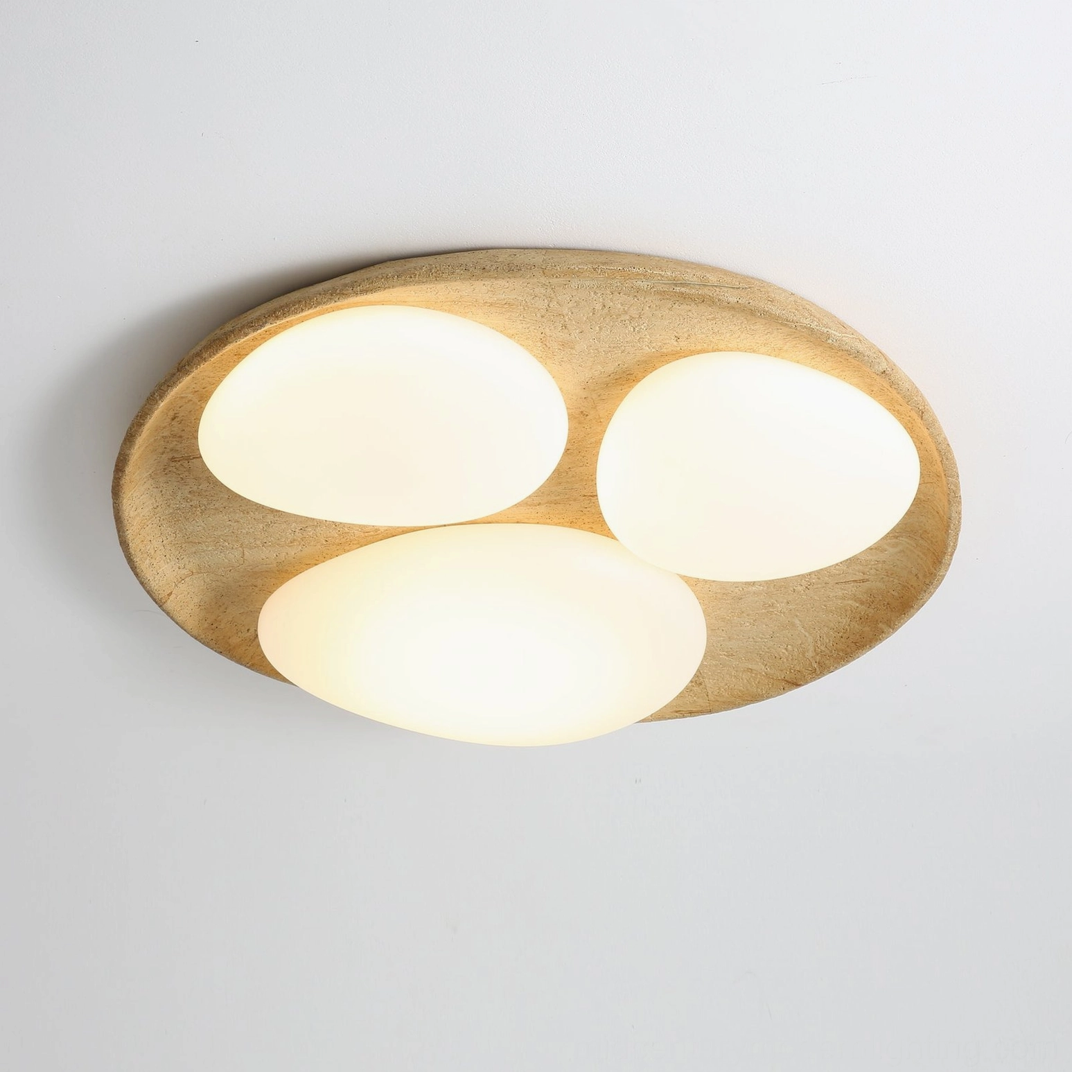 Topo contemporary ceiling fixture overhead front view studio background irregular oval base three frosted acrylic shades