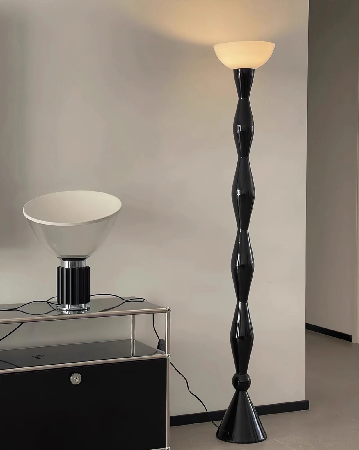 Sculptural black torchiere floor lamp base and twisted metal construction detail shot