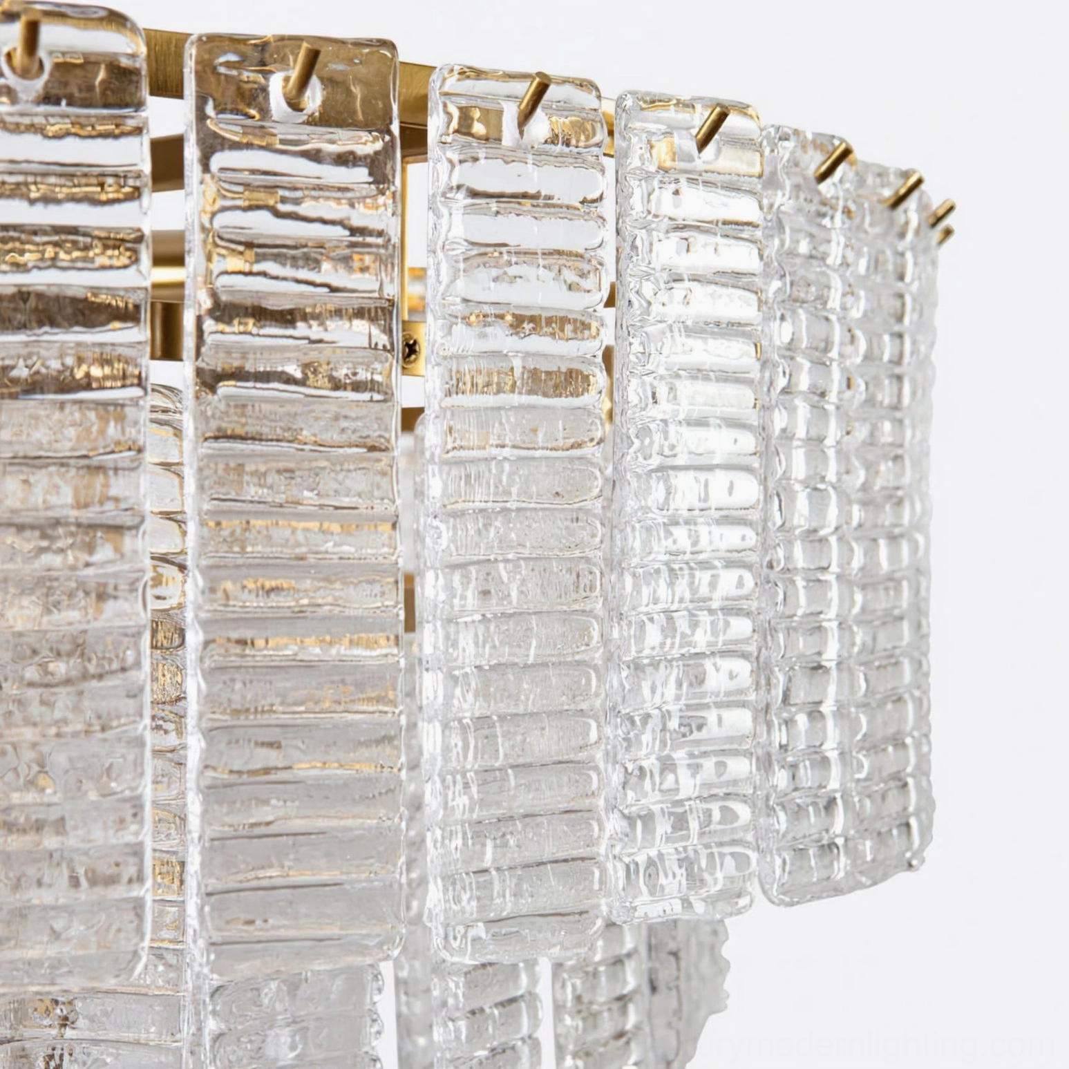 Macro close-up of Toronto chandelier clear ribbed glass strips showing stacked design and gold brass mounts