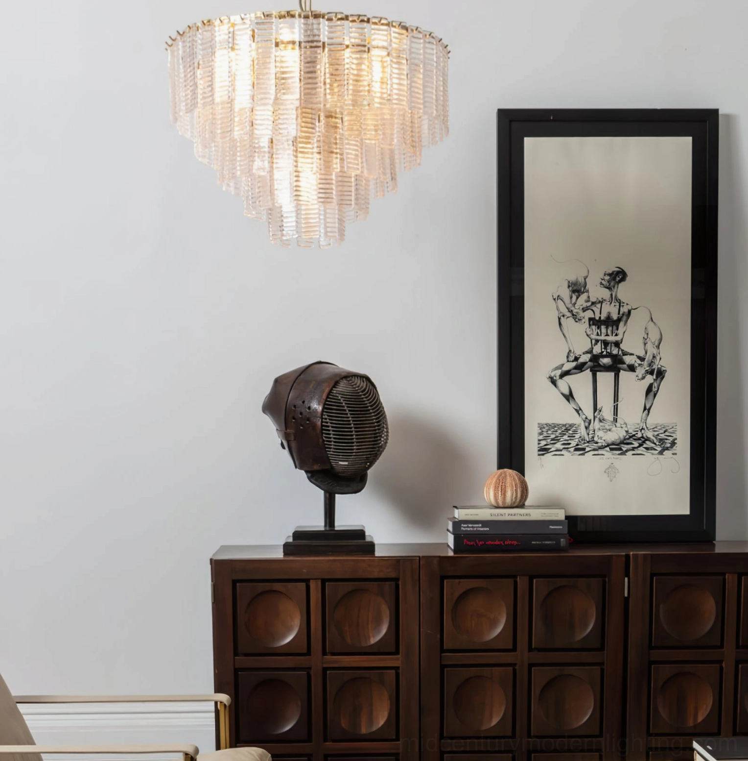 Clear frosted tiered Toronto chandelier in mid-century modern living room with vintage cabinet and wall art