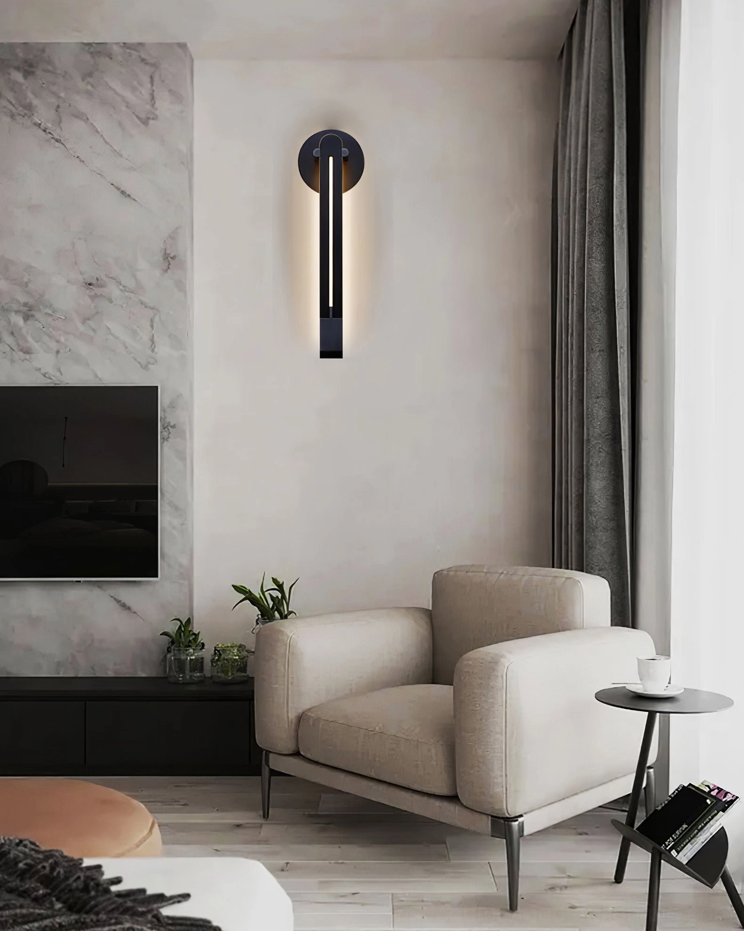 Single Torpedo wall sconce in black mounted in living room above armchair with TV feature wall, modern luxury interior
