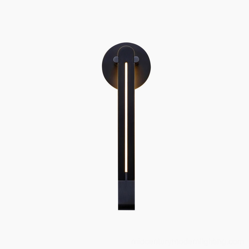 Torpedo wall sconce in pure black matte finish mounted in contemporary interior, minimalist architectural lighting