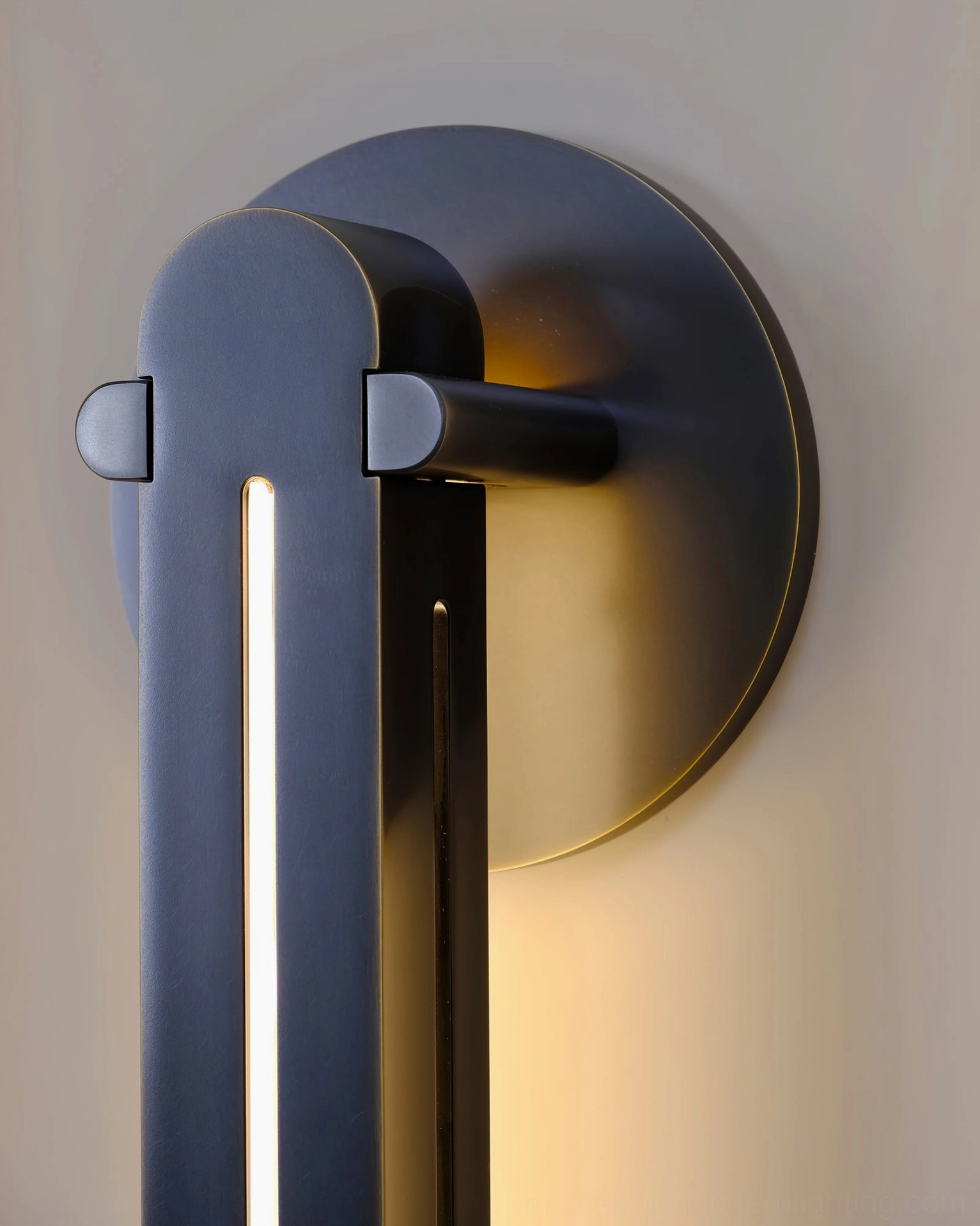 Close-up detail of Torpedo sconce brass and black finish showing contemporary minimalist sculptural form