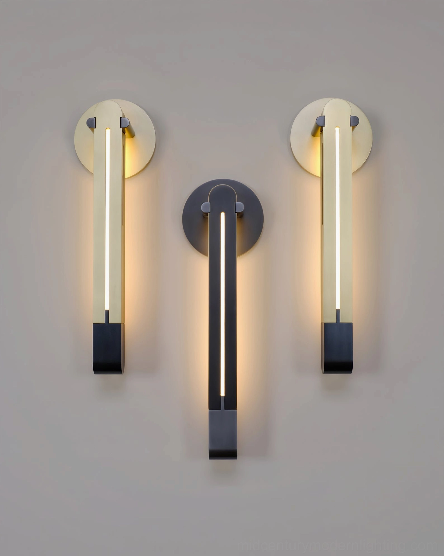 Multiple Torpedo LED wall sconces in black and brass plus black finishes arranged on white background showing finish options