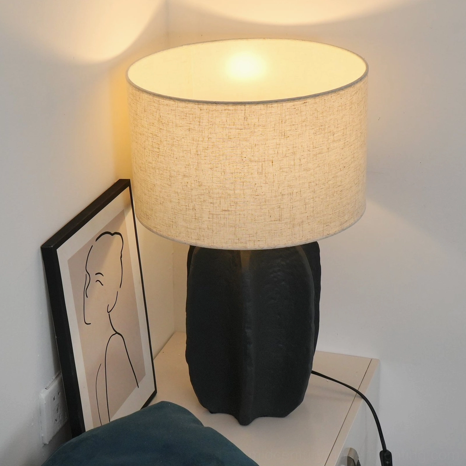 Torso table lamp showing fabric shade quality and light diffusion capability