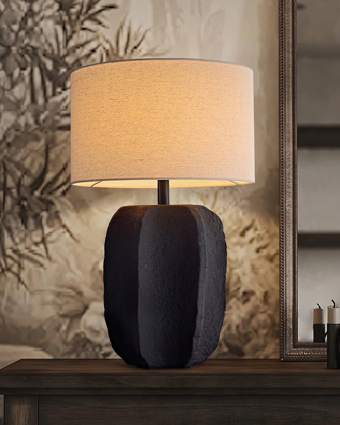Torso sculptural lamp three-quarter view on dark wooden console with Chinese ink painting