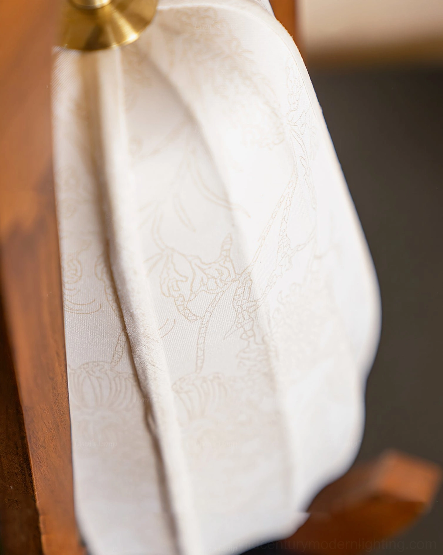 Detailed side close-up of Totem fabric shade showing subtle floral texture pattern and craftsmanship