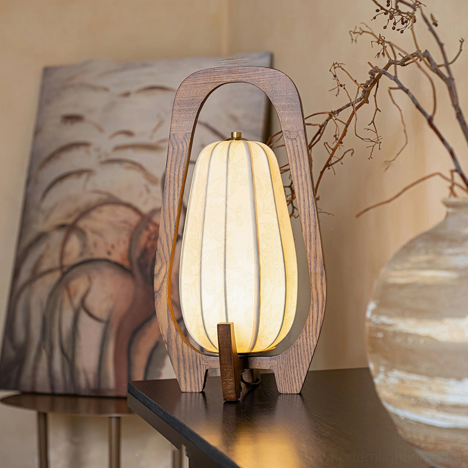 Totem table lamp in warm interior setting with artwork and dried flowers, side perspective showing fabric shade detail