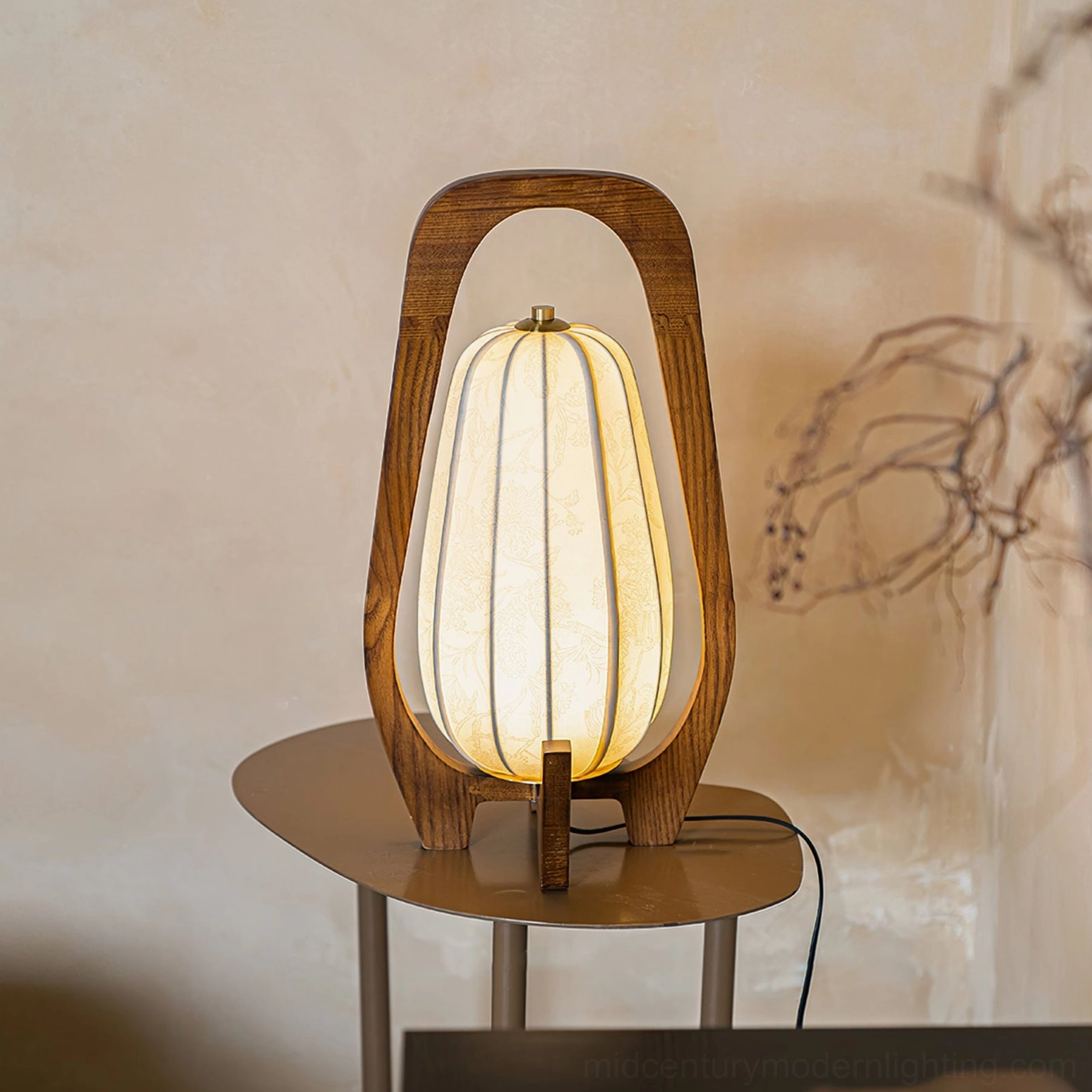 Totem wood table lamp positioned on side table, three-quarter front view displaying walnut wood frame and delicate fabric shade
