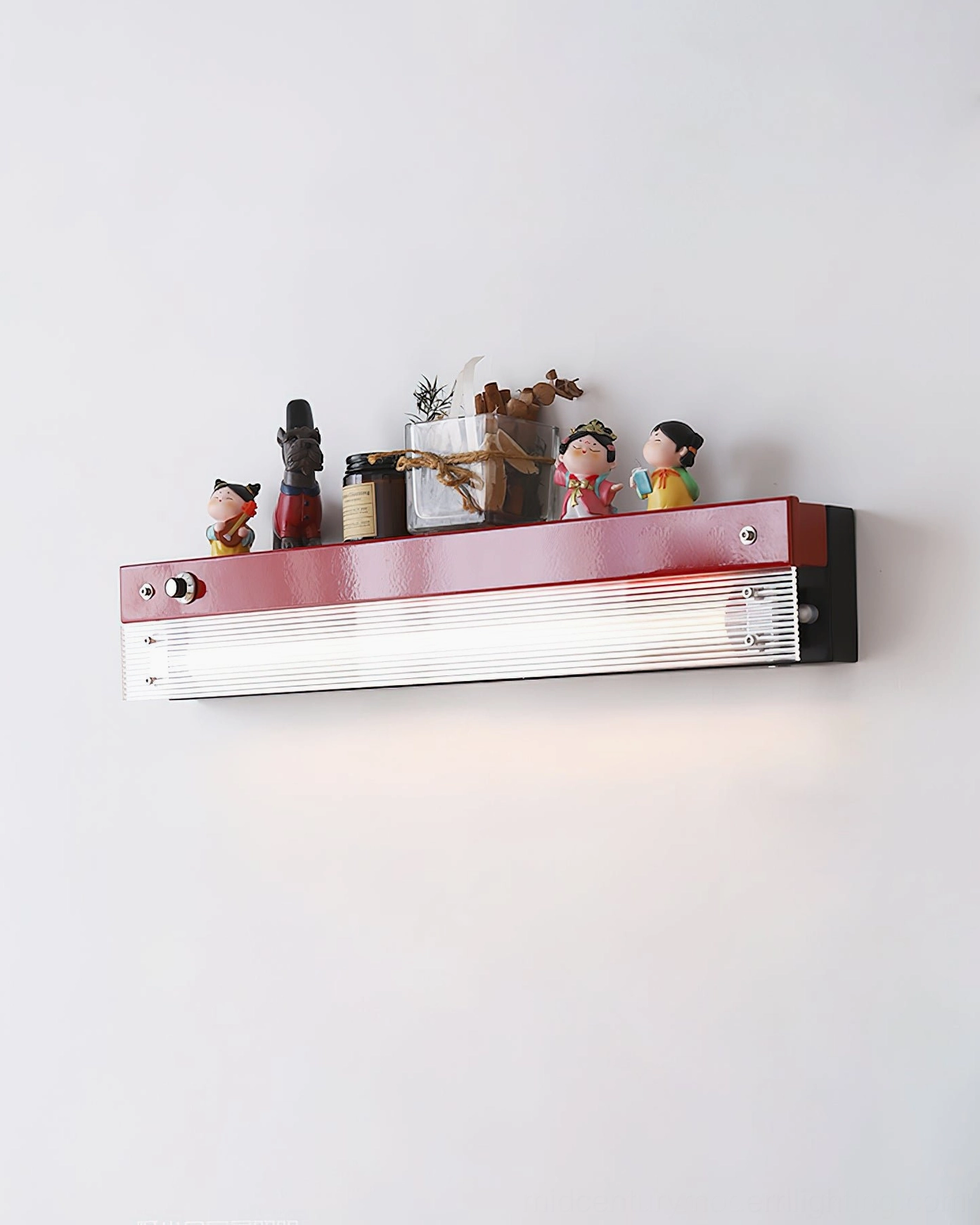 Totem wall lamp with burgundy finish, multiple ornaments, and ambient interior lighting