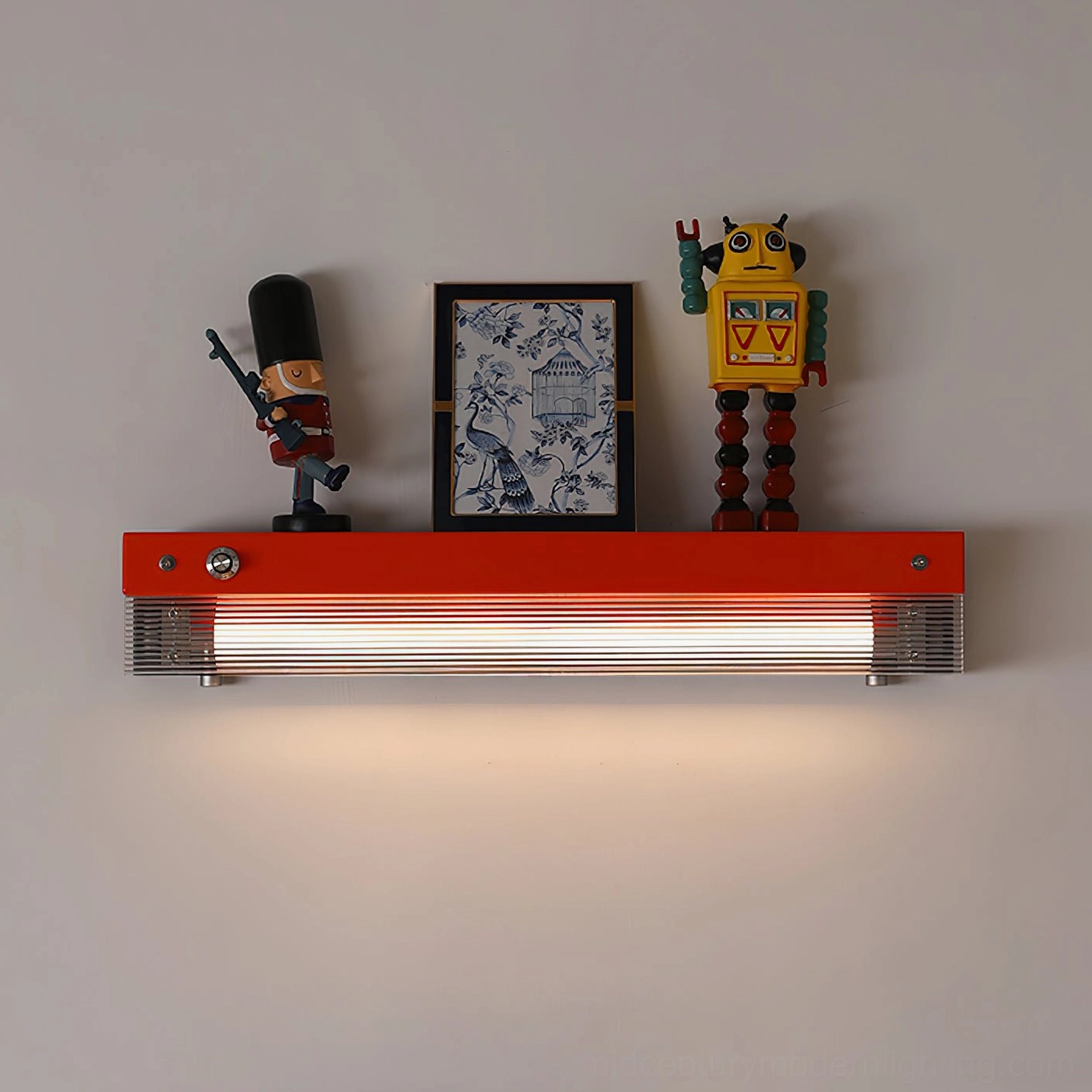 Totem wall lamp displaying framed artwork and classic decorative figures with accent lighting