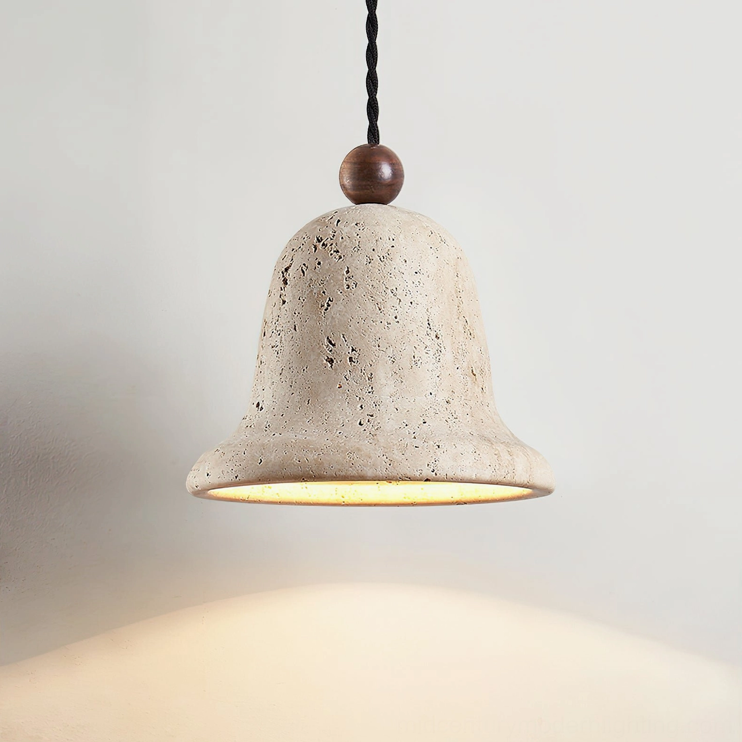 Travertine bell pendant close-up highlighting organic honeycomb texture and warm beige tones