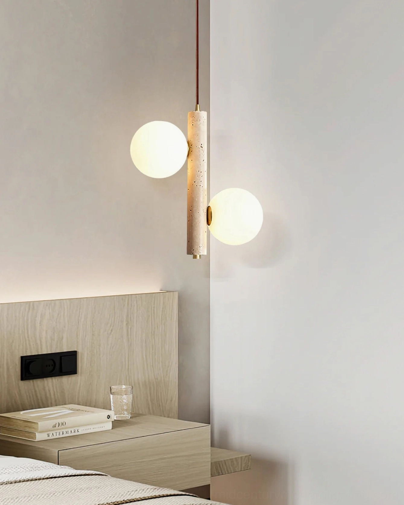 Two-head travertine bubble pendant lamp in compact bedroom space with warm glowing glass spheres, minimalist design