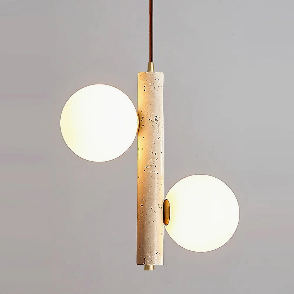 Two-head travertine bubble pendant lamp lit with warm white light, brass hardware visible, wabi-sabi minimalist aesthetic