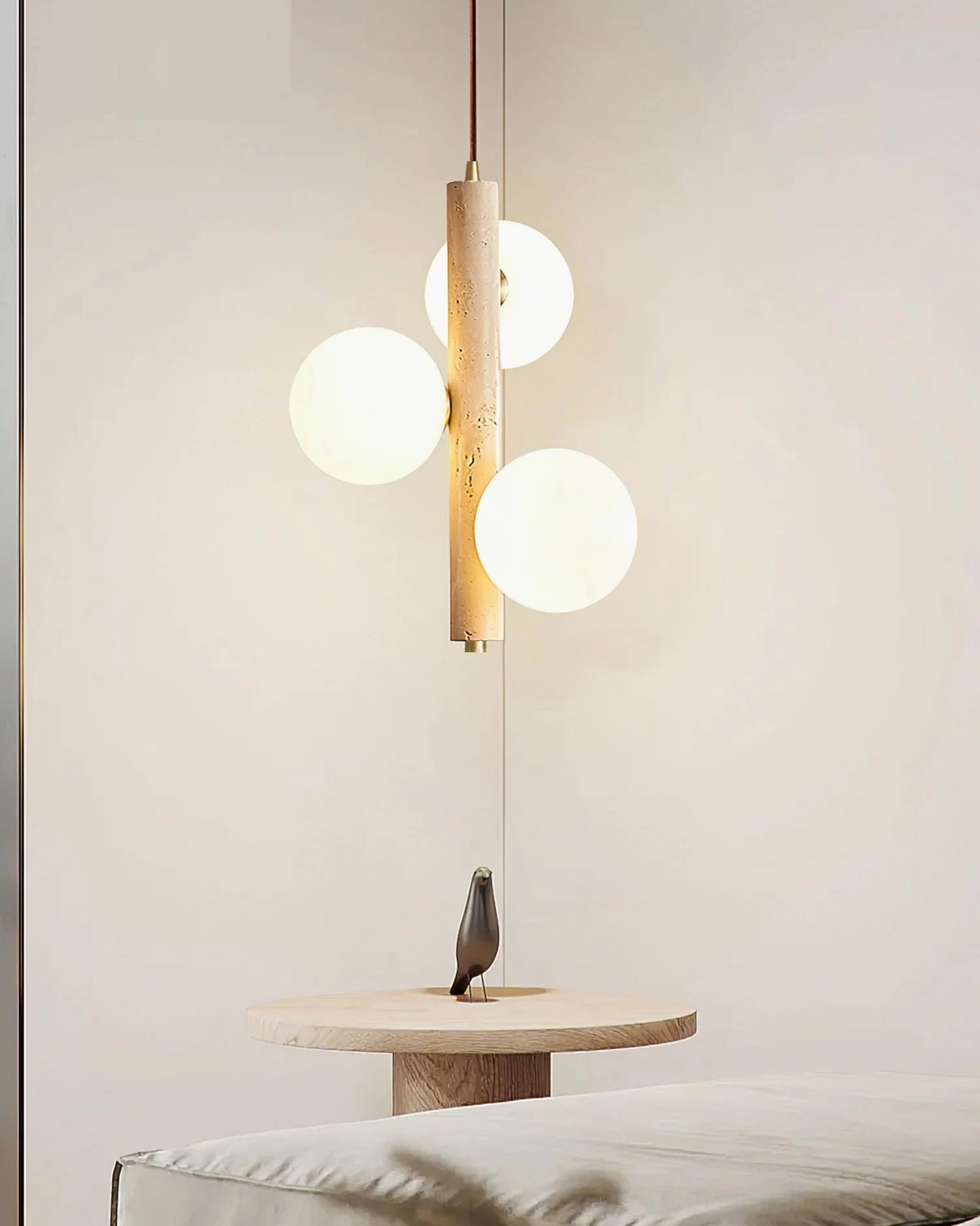 Travertine bubble pendant lamp unlit showing frosted white glass spheres and natural stone texture details in minimalist bedroom