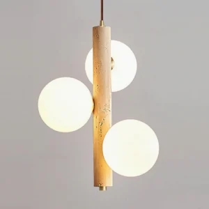 Close-up of travertine bubble pendant lamp illuminated, highlighting warm glow through frosted glass and porous stone texture details
