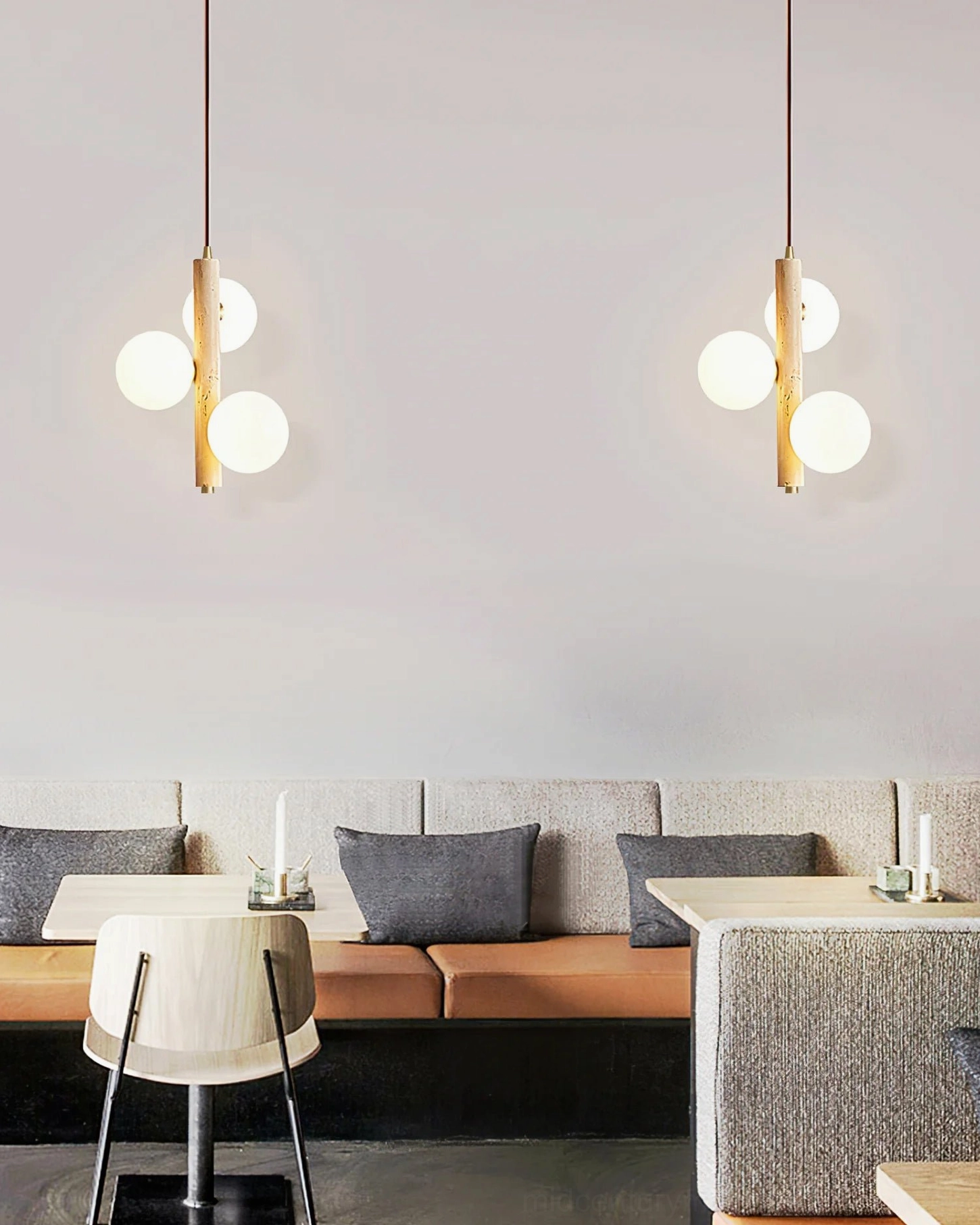 Pair of three-head travertine bubble pendant lights in open-plan living dining area, neutral modern home decor styling