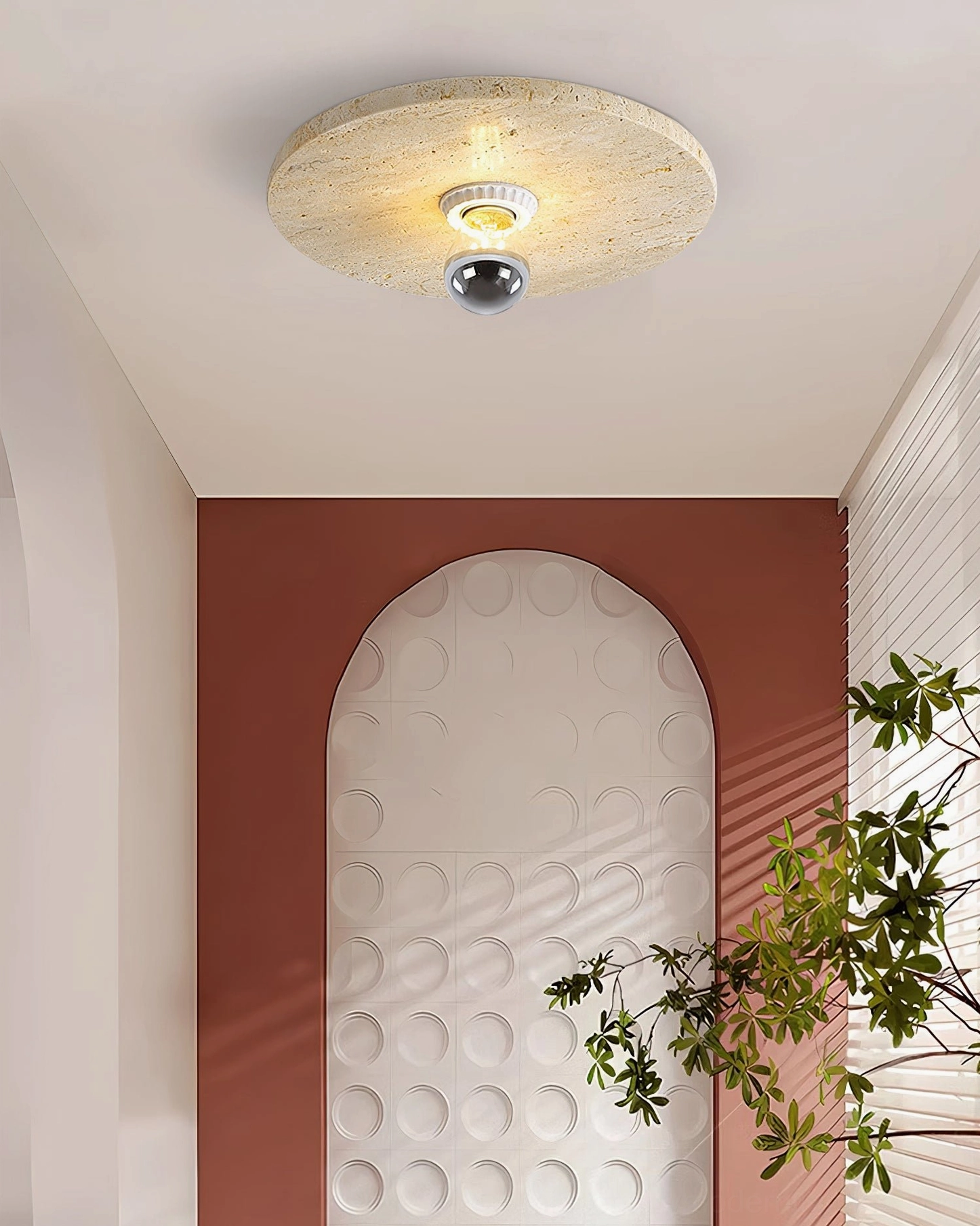 Residential entryway with arched accent wall travertine stone ceiling lamp and terracotta decorative accents