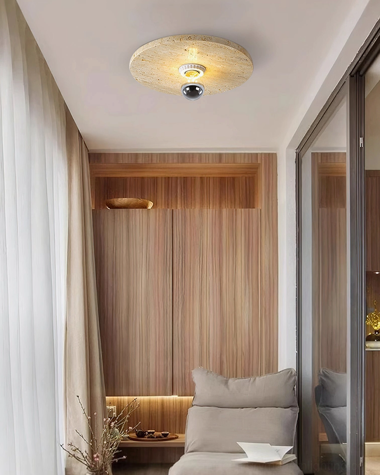 Modern minimalist reading corner with travertine flush mount ceiling lamp in residential bedroom interior design