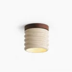 Travertine ceiling lamp with ribbed texture, beige and walnut finish, frontal studio view