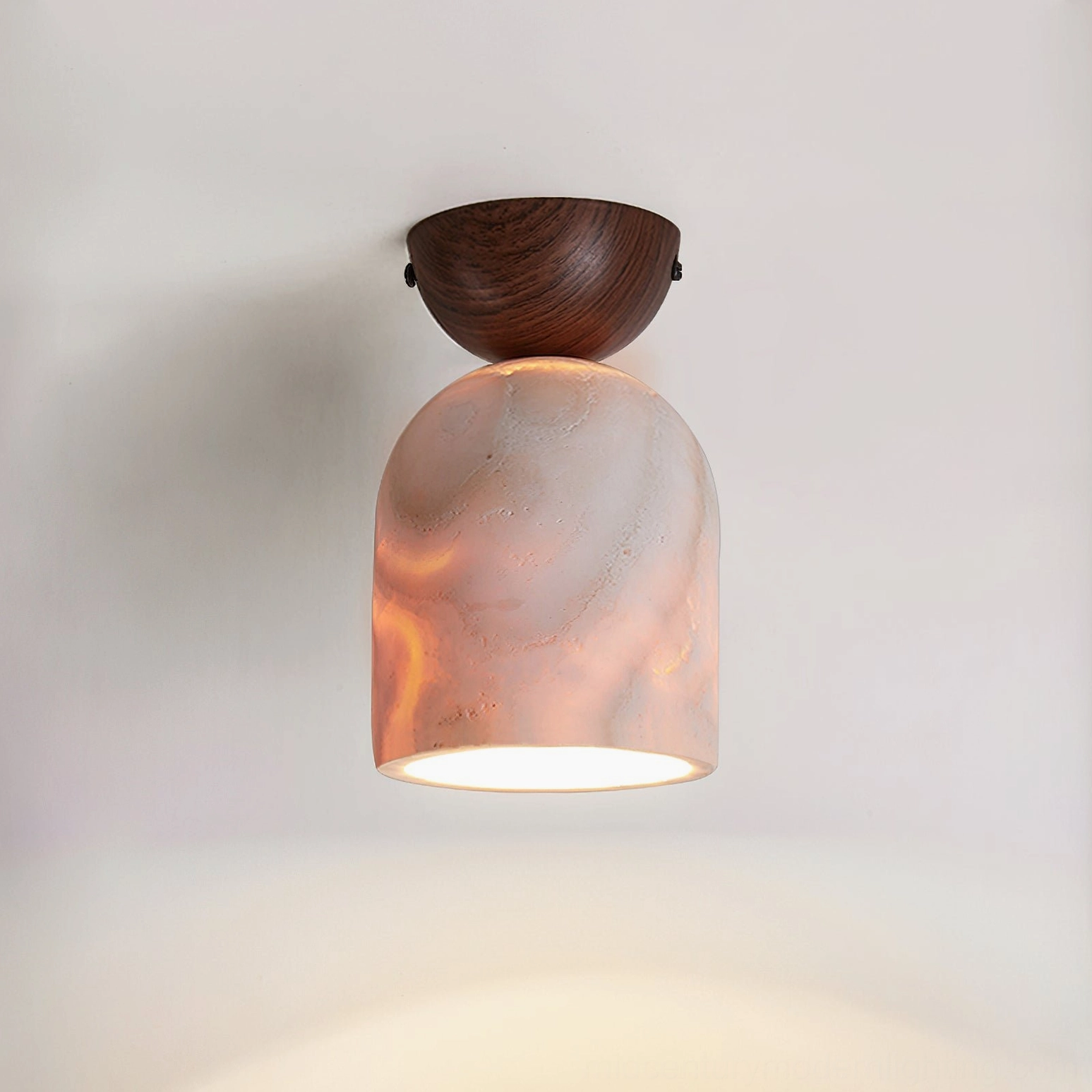 Travertine ceiling lamp with dark walnut wood mount and pink marbled lit shade on white background