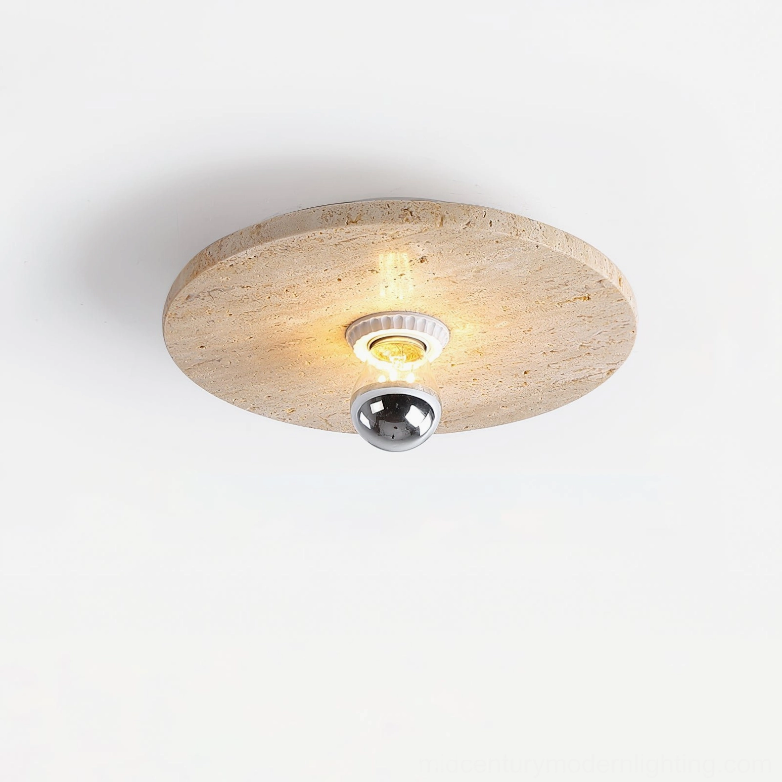 Illuminated natural travertine stone ceiling lamp with LED bulb and polished metal hardware visible through porous surface