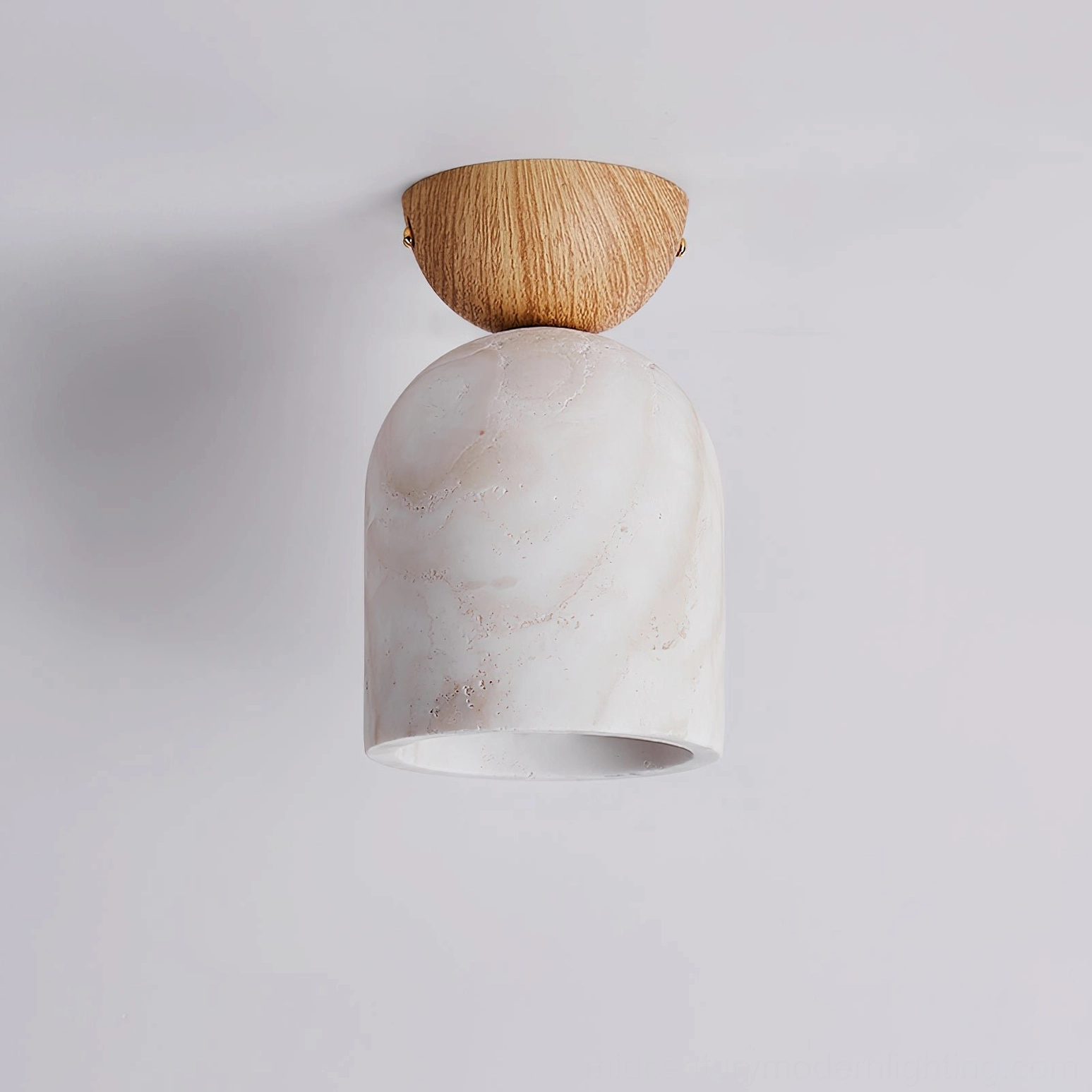 Travertine ceiling lamp with light wood mount and plain white unlit shade on light gray wall background