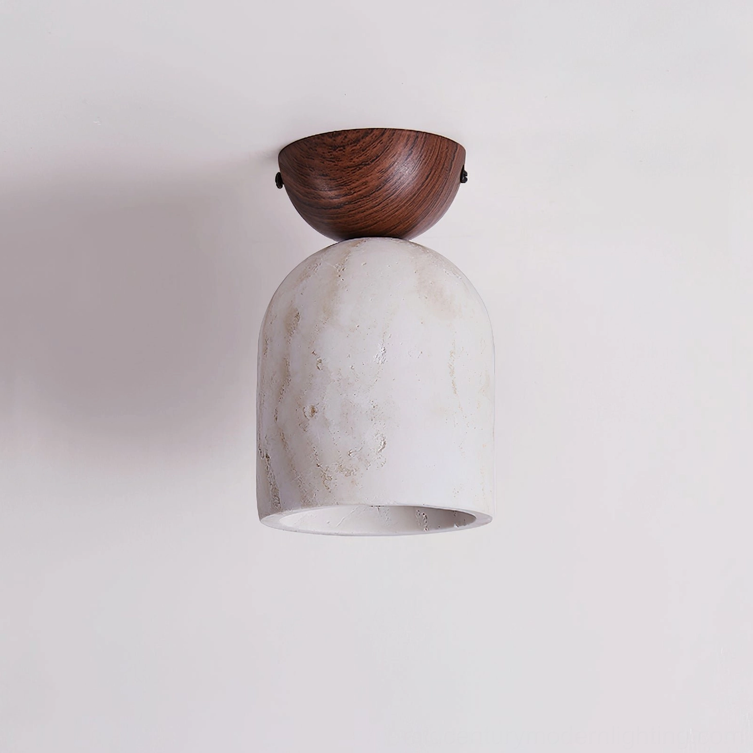 Travertine ceiling pendant with dark walnut mount and plain white unlit shade against light gray wall