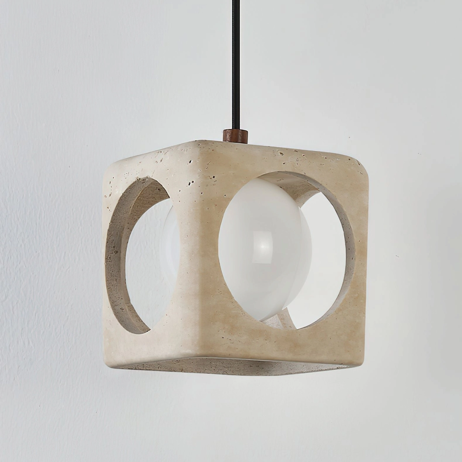 Beige travertine pendant light architectural detail showing geometric cutouts and stone craftsmanship