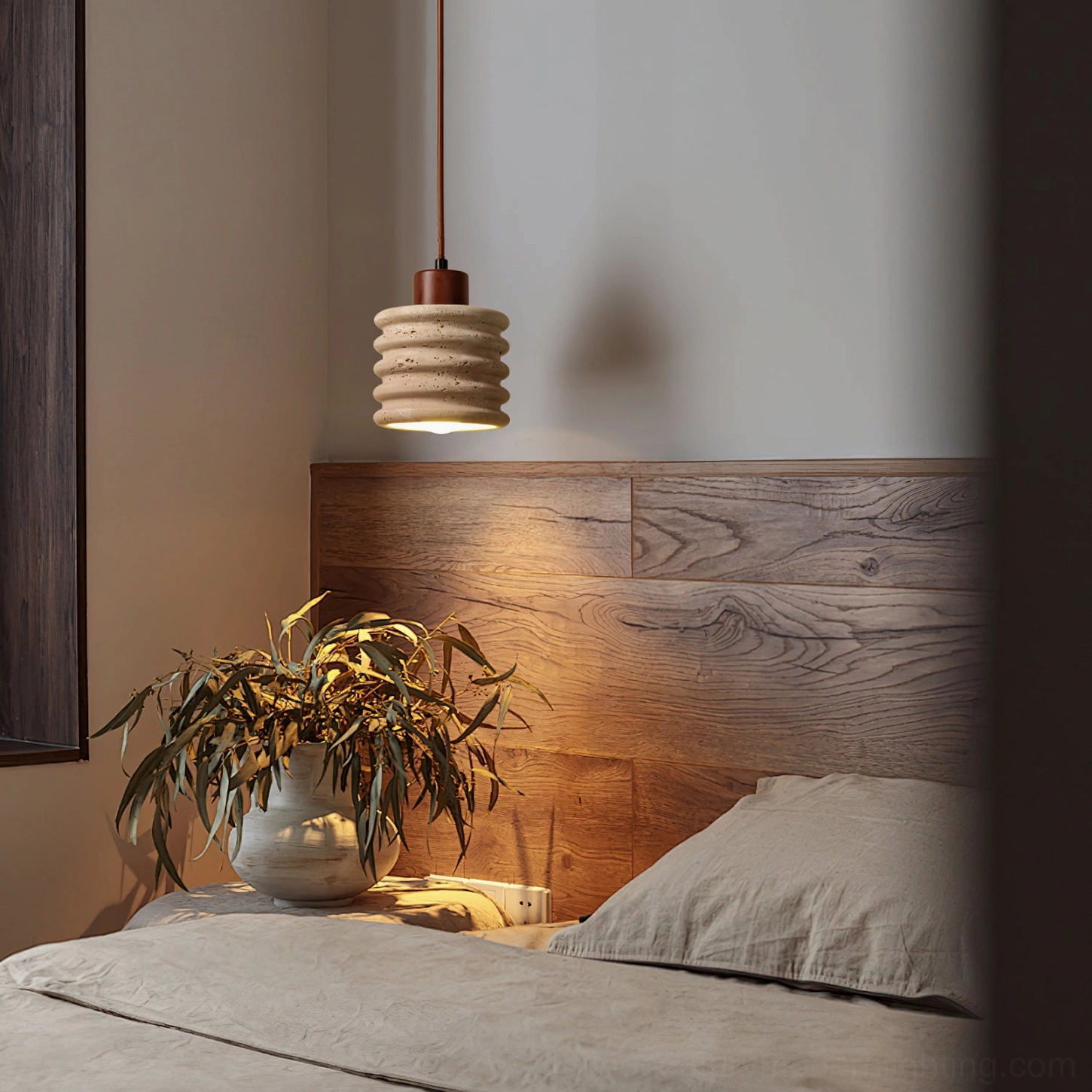 Travertine pendant light installed in modern bedroom beside wooden headboard, warm ambient lighting demonstration