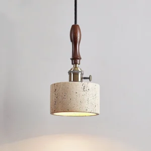 Close-up side view of travertine pendant light highlighting brass switch knob and wooden handle detail