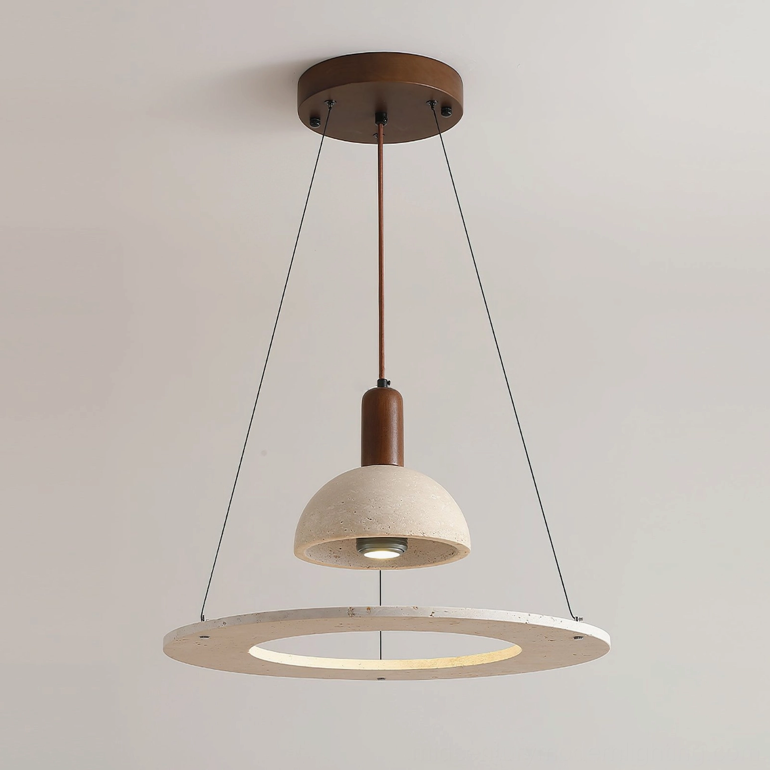 Overhead frontal view of travertine dome pendant light displaying wabi-sabi aesthetic and walnut ring suspension