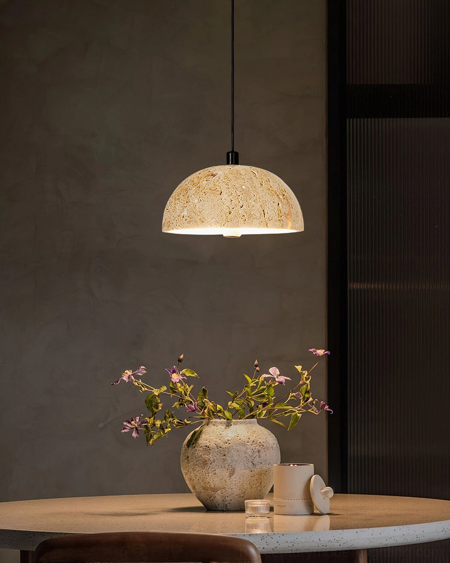 Morphe stone pendant light dining space warm accent wall flower arrangement