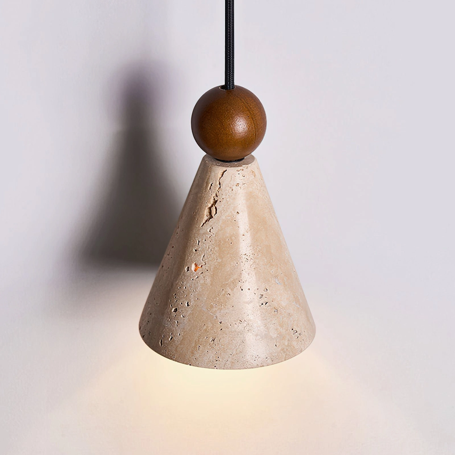 Side profile of travertine cone shade pendant highlighting natural stone texture and craftsmanship