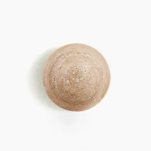 Yellow travertine round wall lamp front close-up showing natural stone texture and wabi-sabi character against white background