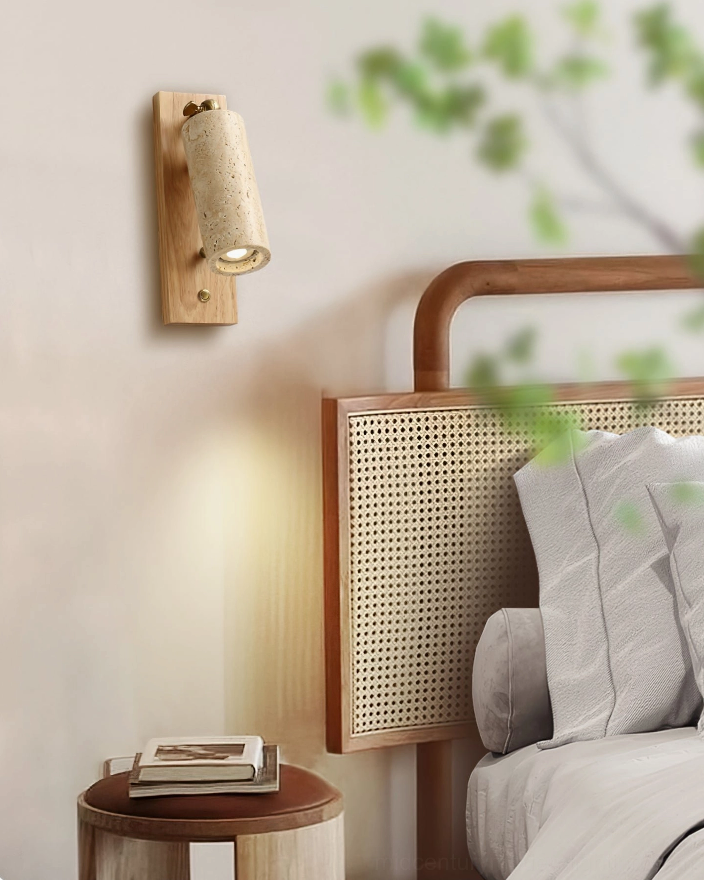 Left side wall perspective of travertine sconce in bedroom setting with rattan bed and oak wood backplate