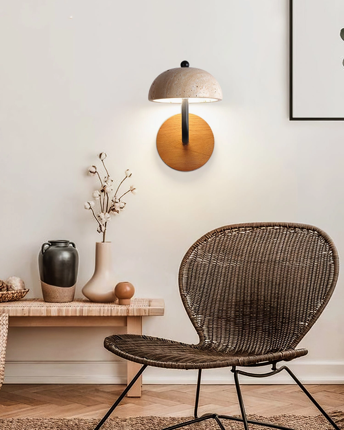 travertine wall sconce in bohemian living room with rattan chair and natural decor