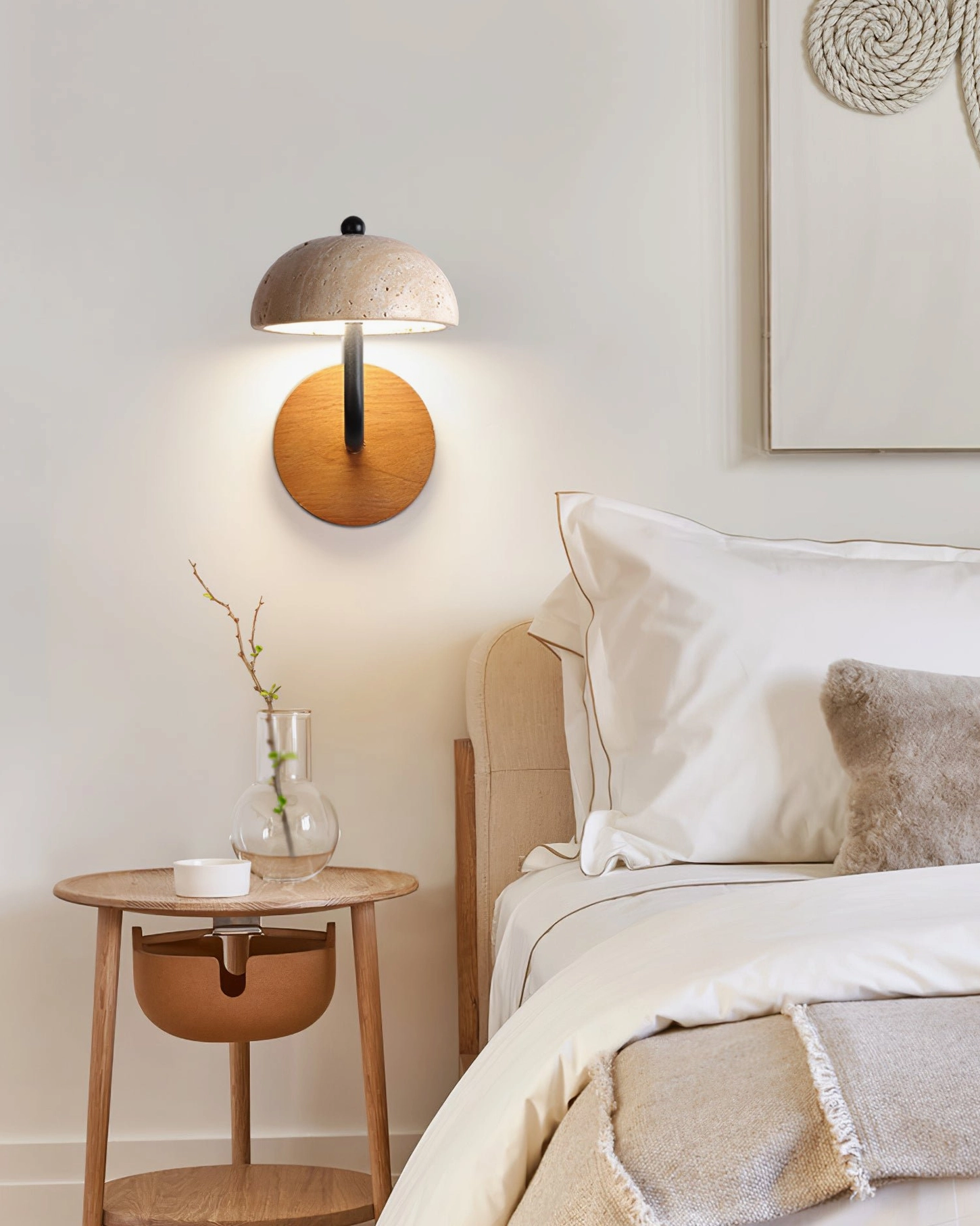 travertine wall sconce illuminating master bedroom bedside area in warm light