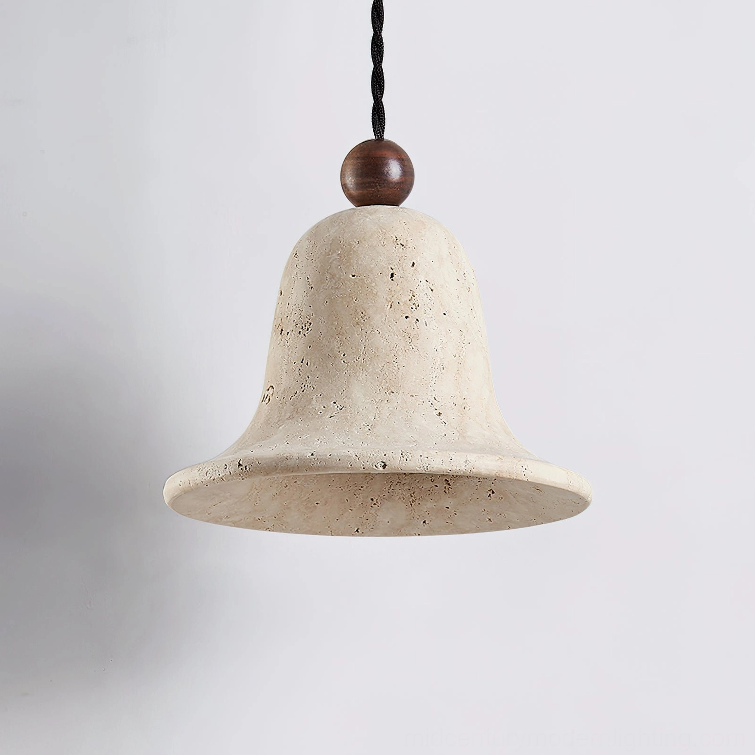 Side view of travertine bell pendant showing porous stone texture and dark wood fixture detail
