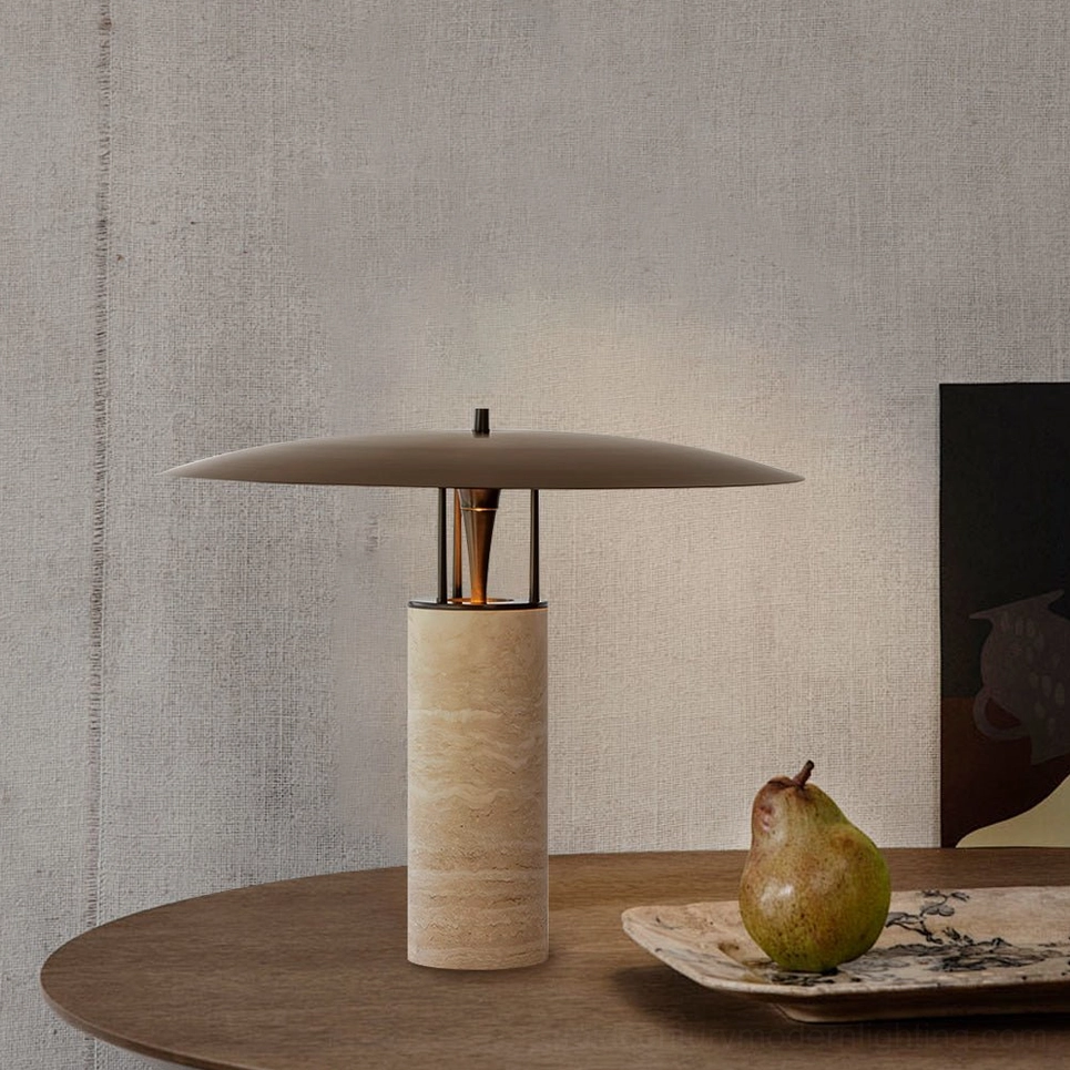 Close-up travertine table lamp on round wooden table with ceramic plate and pear fruit, organic home styling