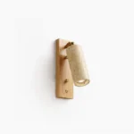 Travertine wall sconce with brass hardware and adjustable cylindrical shade, front flat close-up on white background