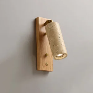Three-quarter side view of travertine sconce with wooden backplate and warm natural stone shade