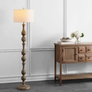 Tremblay floor lamp illuminated in traditional entryway, warm amber light from fabric shade, rustic farmhouse setting
