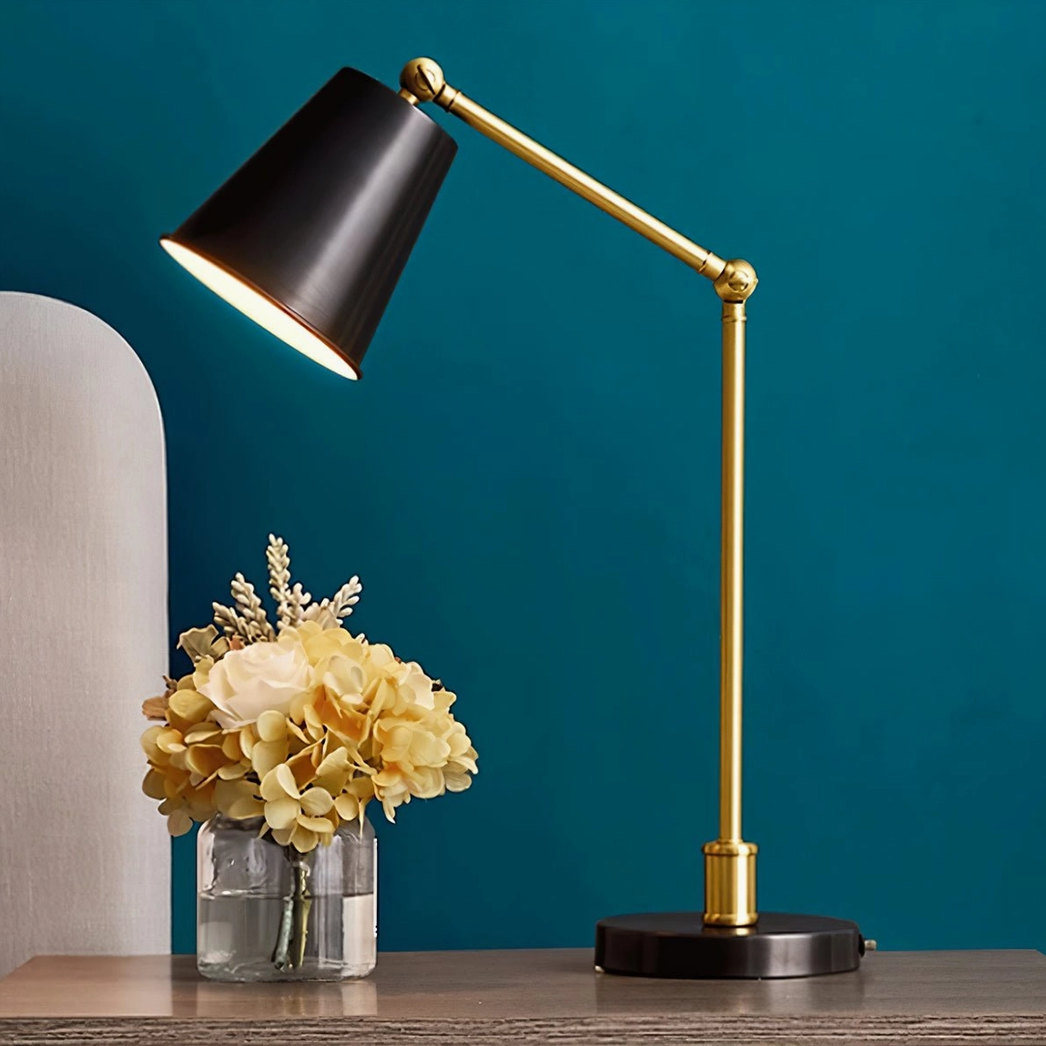 Tresa swing arm brass desk lamp flat view with teal accent wall modern minimalist workspace